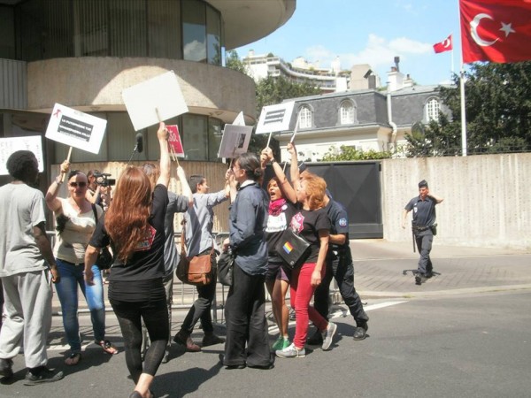 Paris Justice for Dora protest at the Turkish embassy. Participants hold signs saying "transphobi odlurur"—"transphobia kills" in Turkish. The protest was organized by French sex workers' rights organization STRASS and its trans* rights branch, Acceptess-T. (Photo by Virginia Saighi, courtesy of Elisa Aytug Kamal Bayar and Luca Stevenson)